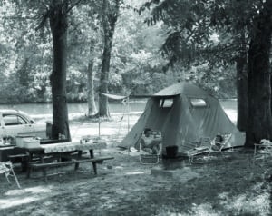 A mom and son camping around 1920.