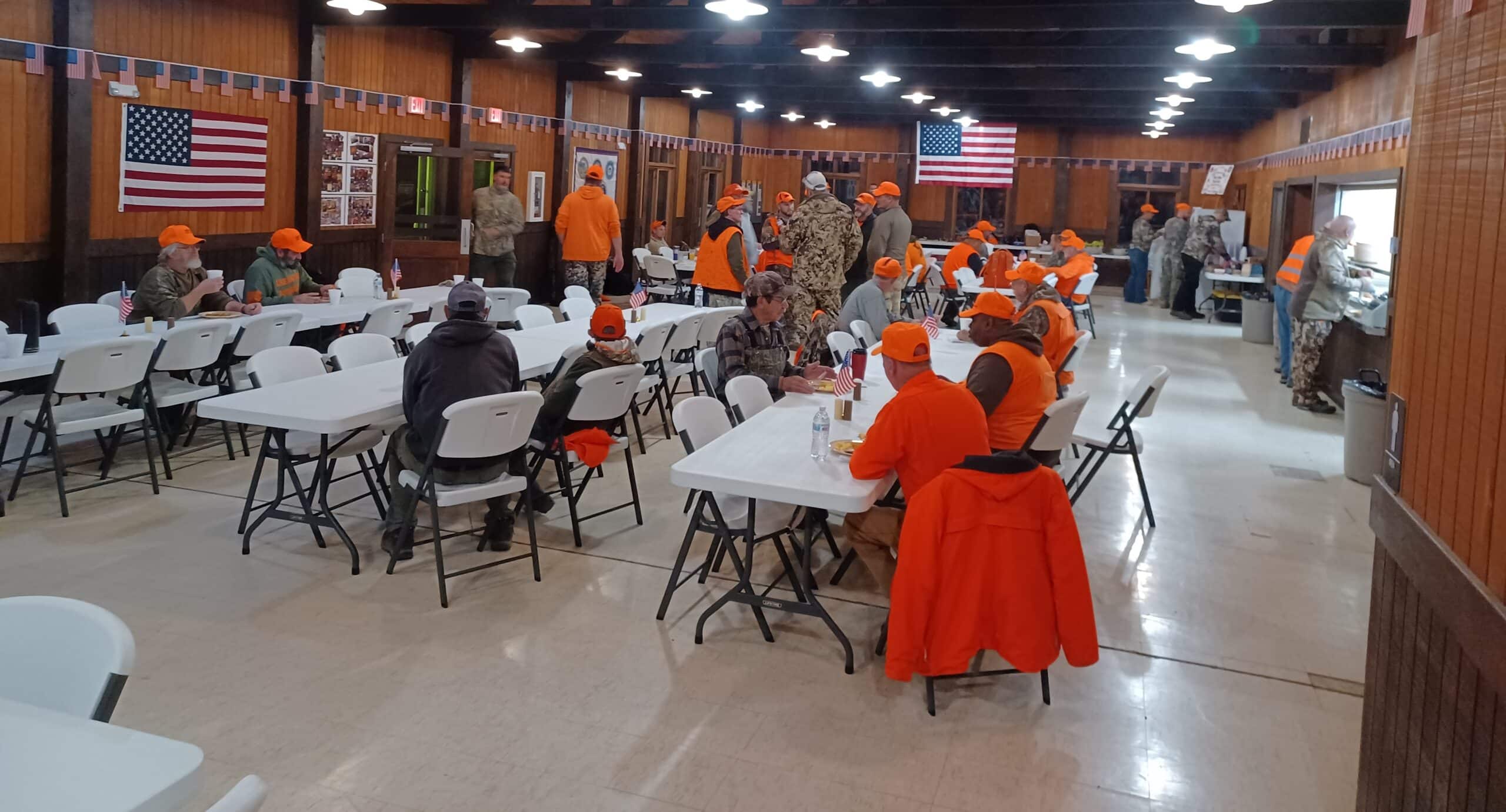 Veterans, staff members and volunteers enjoy a meal together.