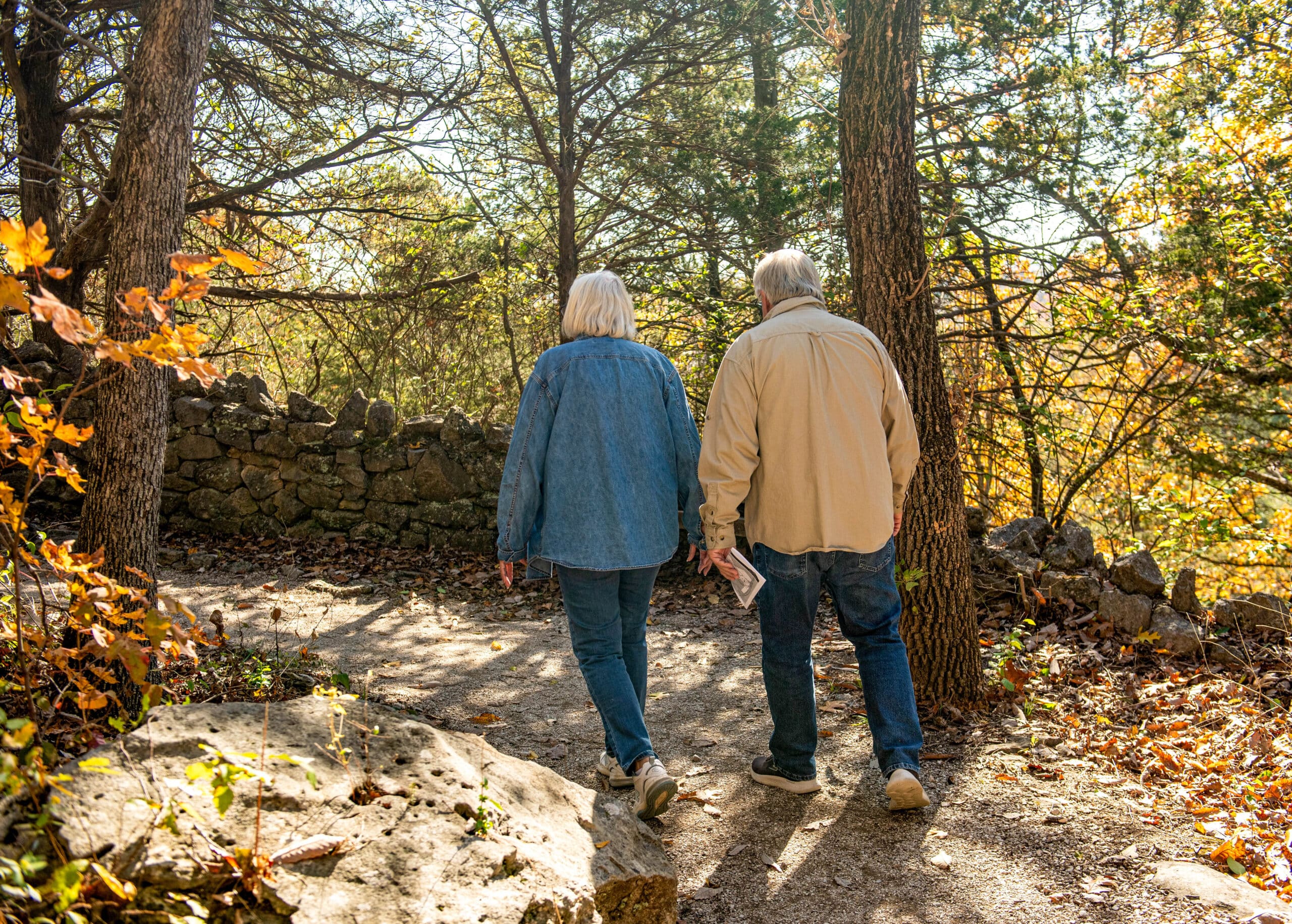 Volunteer, couple walking on a trail